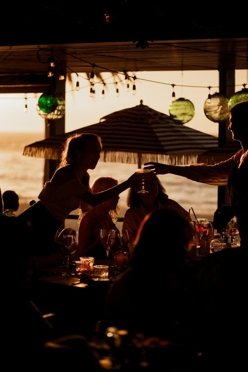 A toast at sunset, glass meeting glass