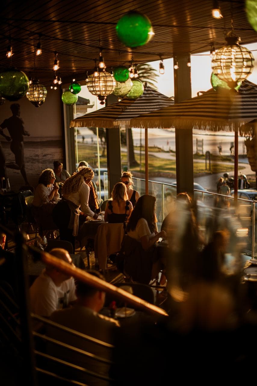Diners on the balcony at golden hour